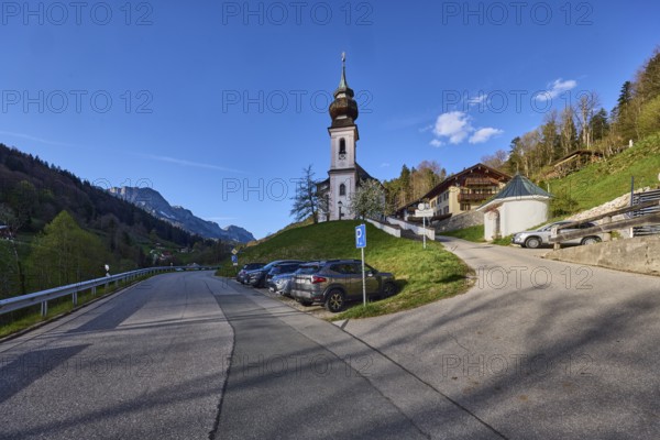 Maria Gern pilgrimage church, church, mountain landscape, hills, mountains, coniferous forest, road, crash barrier, delineator, parking boxes, vehicles, shadow, blue sky, cumulus clouds, intersection of Gerner Straße with Kirchplatz Gern, Maria Gern district, Berchtesgaden, Upper Bavaria, Berchtesgadener Land district, Bavaria, Germany