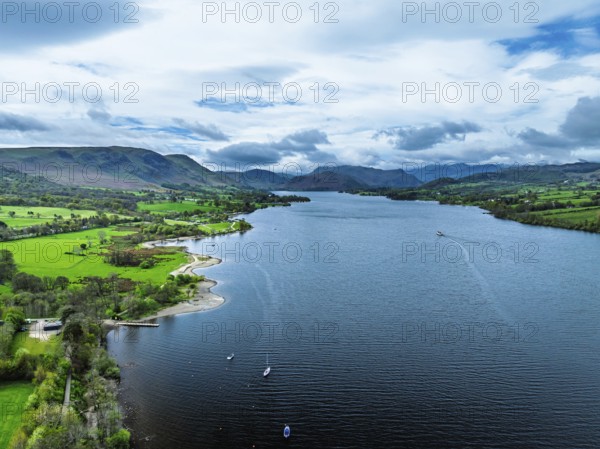 Farms and mountains over Ullswater Lake from drone, Pooley Bridge, Lake District National Park, Cumbria, England, United Kingdom