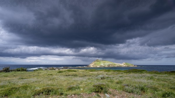 Coast and dark storm clouds near Port de Centuri, Cap Corse, Haute-Corse, Corsica, France