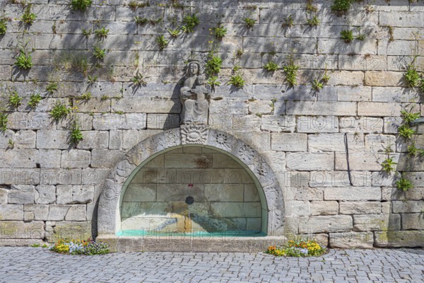 Town wall with a fountain on Marienplatz in Kronach, Germany