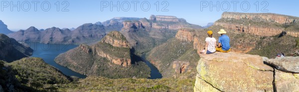 Two hikers enjoying panorama, Blyde River Canyon with Three Rondawels peak, view of gorge with Blyde River and table mountains, canyon landscape, Panorama Route, Mpumalanga, South Africa