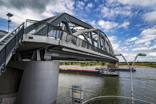 Cycle and pedestrian bridge Snelbinder Brug, over the river Waal near Nijmegen, was added to the existing railway bridge, fast cycle path connection from the city centre of Nijmegen and the new housing estates in the Waalsprong district, Netherlands