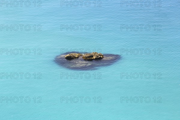 Small group of rocks in the turquoise-coloured sea with calm water, Ricadi, Capo Vaticano
