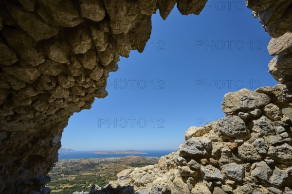 View through a ruined opening onto a landscape with blue sky, Abandoned Village, Lost Place, Pyli, Paleo Pyli, Byzantine Fortress, Kos, Dodecanese, Greek Islands, Greece