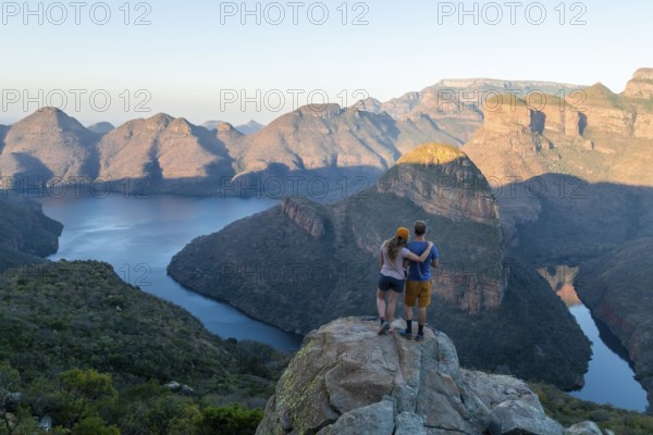 Two hikers enjoying panorama, Blyde River Canyon with Three Rondawels peak, view of gorge with Blyde River and table mountains, canyon landscape, Panorama Route, Mpumalanga, South Africa