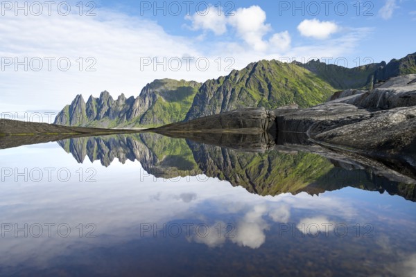 Reflection in a tidal pool, rocky coast of Tungeneset, Devil's Teeth, Okshornan, Ersfjorden, Senja Island, Troms, Norway