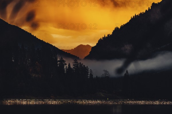 Surreal light atmosphere at sunrise at Plansee, Tyrol, in the Alps in Austria