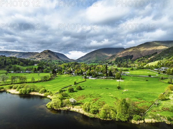 Farms and Mountains over road A591 from a drone, Grasmere Lake, Grasmere, Ambleside, Lake District, Westmorland, Cumbria, UK