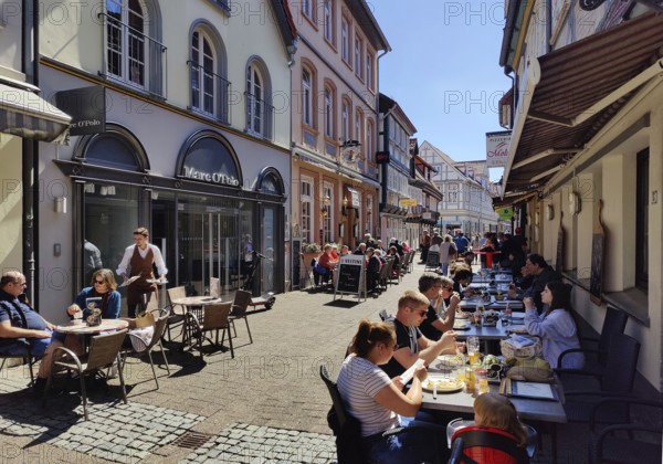 People in the outdoor catering area in the old town, Celle, Lower Saxony, Germany