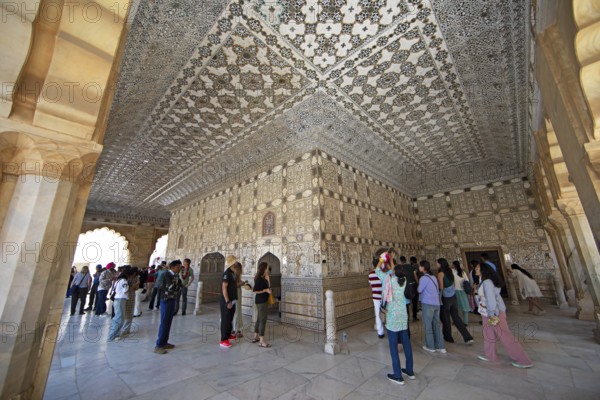 Visitors in the audience hall in the Amber Fort or fortress, Jaipur, Rajasthan, India