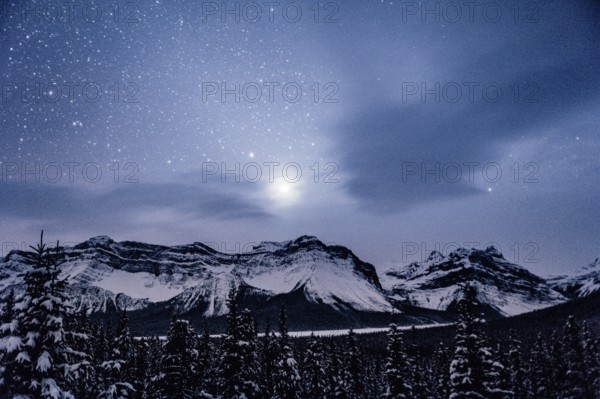 Starry sky during a winter road trip on the Icefields Parkway with lots of snow and ice, Banff National Park, Jasper National Park, Alberta, Canada