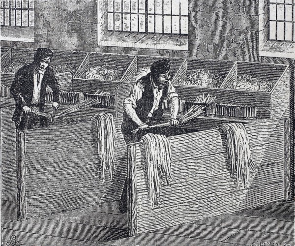 Textile industry, spinning mill, men working on a hand hackle, tool made of wood or metal with vertical metal pins, hackle teeth, used for hackling flax or other fibres, around 1880, digitally enhanced reproduction of a 19th century original, historical, exact date unknown