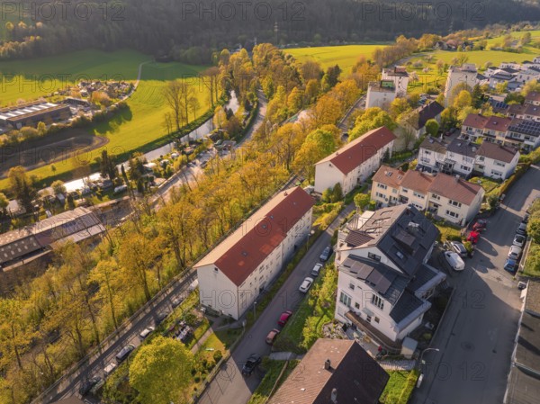 Terraced houses in a rural urban landscape with streets and spring-like trees, Nagold, Calw district, Germany