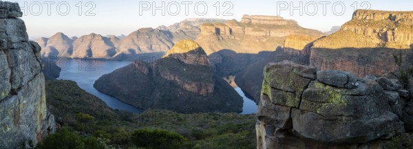 Panorama, sunset at Blyde River Canyon with Three Rondawels peak, view of canyon with Blyde River and table mountains in the evening light, canyon landscape, Panorama Route, Mpumalanga, South Africa