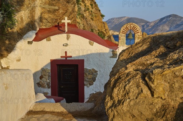 Legend, crab, shell fisherman, rock embedded chapel with view of the sea and mountains in the background, chapel, little church, Agia Kavouradena Monastery, Xirokambos, Leros, Dodecanese, Greek Islands, Greece