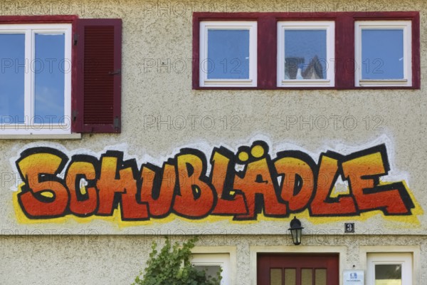 Clothes shop and meeting café Schublädle, mural, house facade, writing, social project, second-hand clothes, church square, shutters, Gomaringen, district of Tübingen, Baden-Württemberg, Germany