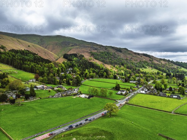 Farms and Mountains over road A591 from a drone, Grasmere Lake, Grasmere, Ambleside, Lake District, Westmorland, Cumbria, UK