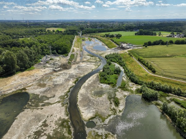 Dortmund, Castrop-Rauxel, North Rhine-Westphalia, Germany - River renaturalisation, renaturation of the Emscher, flood retention basin HRB Mengede. A new floodplain landscape is being created at the Emscher-Auen farm, expanding the area for flood protection during heavy rainfall and for biodiversity. The previously straightened Emscher is being given curves again and can meander through its new floodplain. Following the construction of a parallel sewer, the Emscher has been completely free of sewage since 2022. The river was previously an open, above-ground combined sewer with rainwater and wastewater