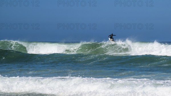 Surfer riding a wave on Contis beach, Saint Julien en Born, Saint-Julien-en-Born, Landes, France