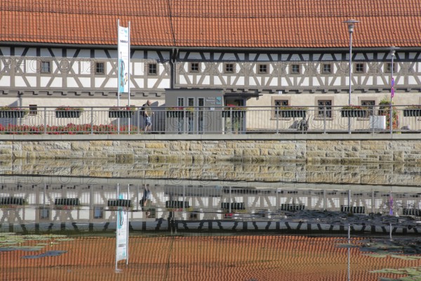 Armoury museum built in 1668 with reflection, half-timbered house, pond, bank, Suhl, Franconia, Thuringia, Germany