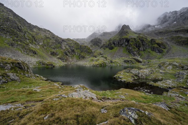 Mountain lake Kreuzsee, cloudy mountain peaks, Schober group, Hohe Tauern National Park, Carinthia, Austria