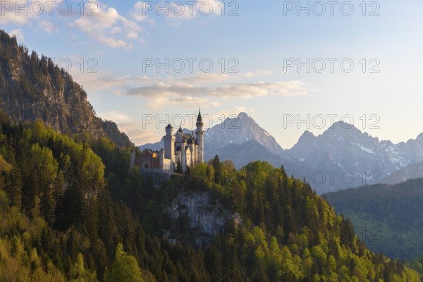 Fantastic castle against an alpine backdrop at dusk, Neuschwanstein, Schwangau near Füssen, Ostallgäu district, Swabia, Bavaria, Germany