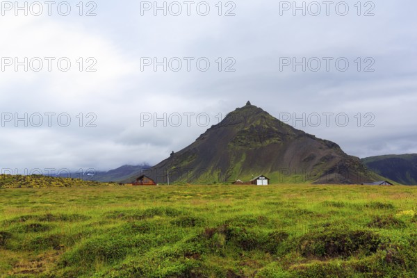 Cone-shaped mountain Stapafell, rain clouds, Arnarstapi, Faxafloi, Snæfellsnes peninsula, Snaefellsnes, West Iceland, Iceland