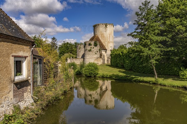The river Loir and the castle with donjon in Alluyes, Centre-Val de Loire, France
