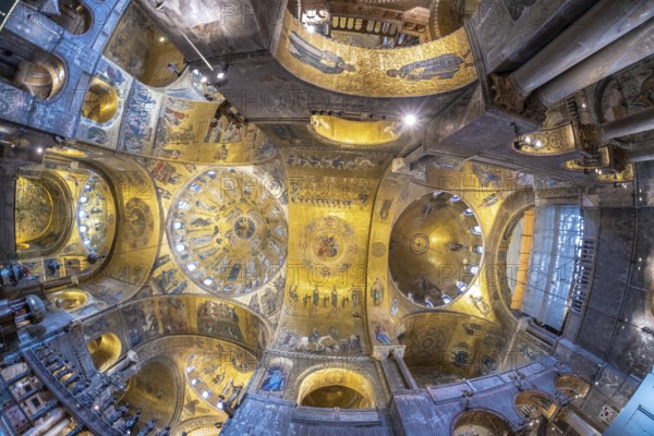 Wide angle view of the magnificent golden mosaics covering the ceiling of saint mark's basilica, a stunning example of byzantine art in venice, italy