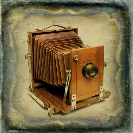 Old wooden camera with bellows displayed against a textured vintage background, showcasing craftsmanship from a bygone era in photography