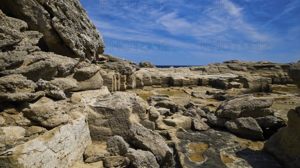 Rough rocky terrain with a view of the sea in sunny weather, Oasis Beach, east coast of Rhodes, Rhodes, Dodecanese, Greek Islands, Greece