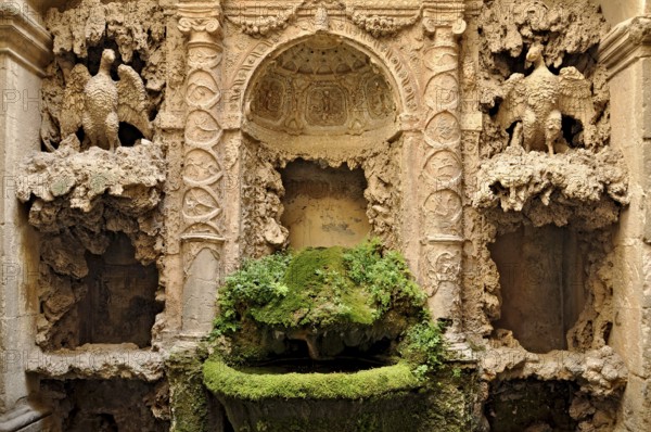 Ornamental fountain from the Renaissance, fountain with moss and artificial dripstone from the Mannerist period, courtyard of Palazzo Conti, historic centre, Poli, Monti Prenestini, metropolitan city of Rome, Lazio, Italy