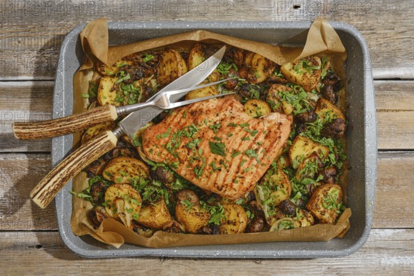 Juicy roasted turkey breast is beautifully presented on a tray with golden, seasoned potatoes and mushrooms, garnished with fresh herbs. Perfect for a festive dinner or holiday gathering