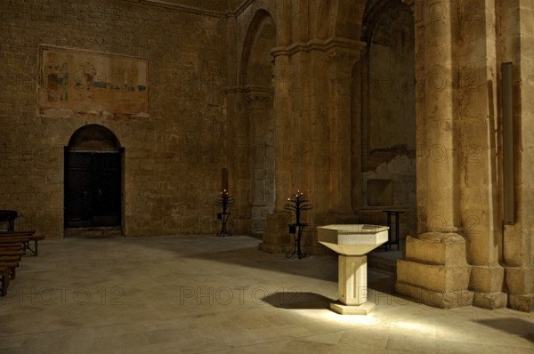 Baptismal font, remains of 14th century frescoes, side chapel, interior, Gothic basilica of the Cistercian abbey of Fossanova Monastery, Cistercian-Burgundian architectural style, Priverno, Province of Latina, Lazio, Italy