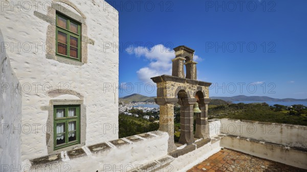 Bell tower on the roof of a white building overlooking the sea, Monastery of the Revelation, Moni tis Apokalipsis, World Heritage Site 1999, Patmos, Dodecanese, Greek Islands, Greece