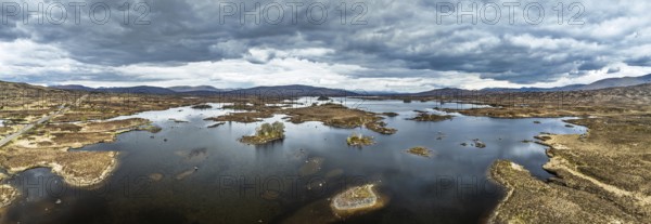 Panorama of Rannoch Moor from a drone over Loch Ba and Loch of the Armpit, A82 Highland Way, Argyll and Bute, West Highlands, Scotland, United Kingdom