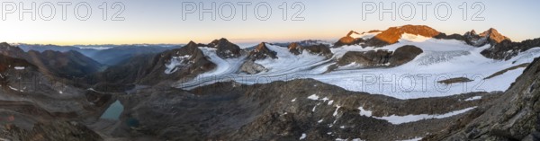 Panorama at sunrise with alpenglow, high mountain landscape, view of blue glacial lakes, mountain peaks Königshofspitz and Hofmannspitze with glacier of the Übeltalferner, Stubai Alps, South Tyrol, Italy
