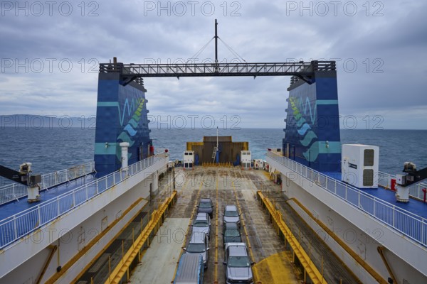 Ferry with parked cars and view of the sea under a cloudy sky, summer, Cook Strait, North Island, South Island, New Zealand