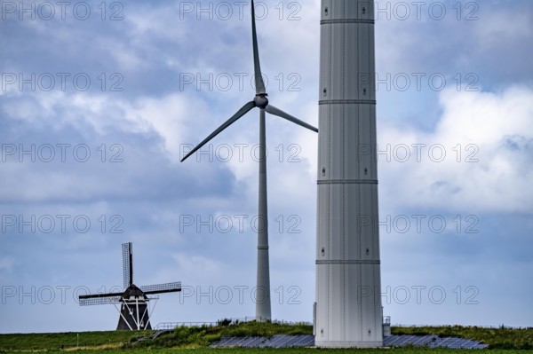Westereems and Growind wind farms, over 80 wind turbines in total, at the Eemshaven seaport, province of Groningen, in the north-west of the Netherlands, historic Goliath windmill from 1897