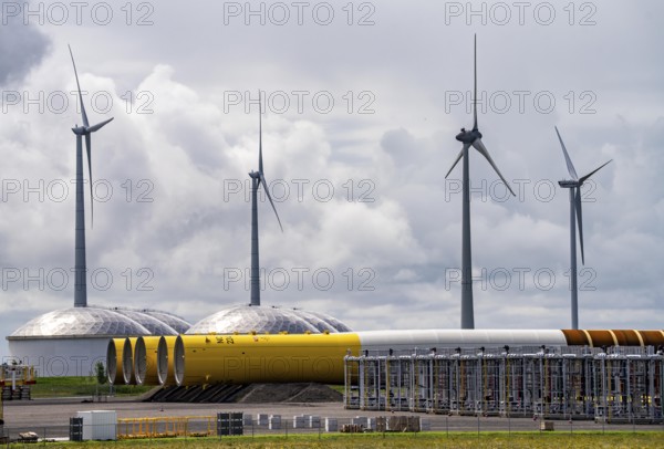 The seaport of Eemshaven, Julianahaven Basin, where the foundation structures, monopiles, for offshore wind farms are stored, which then support the actual wind turbines, the components are transported to the wind farms in the North Sea on large workboats and anchored to the seabed, where the wind turbines are then built, Eemshaven, Netherlands