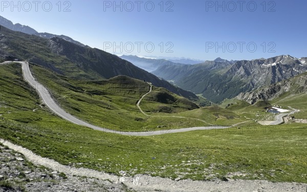 View of southern ramp southern ascent mountain road alpine road to third highest asphalted pass in the Alps highest border pass pass in the high Alps alpine pass above tree line 2744 metre high Col d'Agnel, Colle dell'Agnello, Pontechianale, Piedmont, Italy