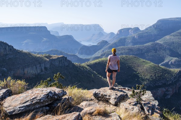 Tourist looking over canyon landscape, view of Blyde River gorge, Lowveld Viewpoint, in the evening light, Blyde River Canyon, Panorama Route, Mpumalanga, South Africa