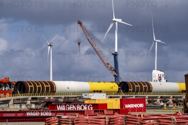 The seaport of Eemshaven, Julianahaven Basin, where the foundation structures, monopiles, for offshore wind farms are stored, which then support the actual wind turbines, the components are transported to the wind farms in the North Sea on large workboats and anchored to the seabed, where the wind turbines are then built, Eemshaven, Netherlands
