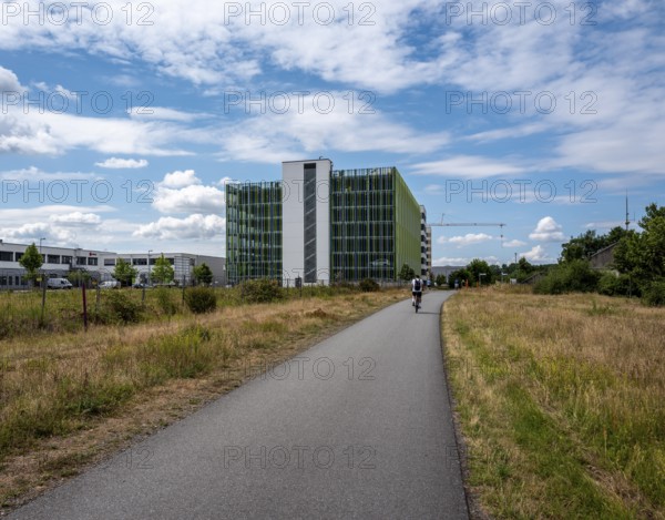 Cycle path on the banks of the Main with the multi-storey car park at the Edersheim lock in the background, Hattersheim, Hesse, Germany