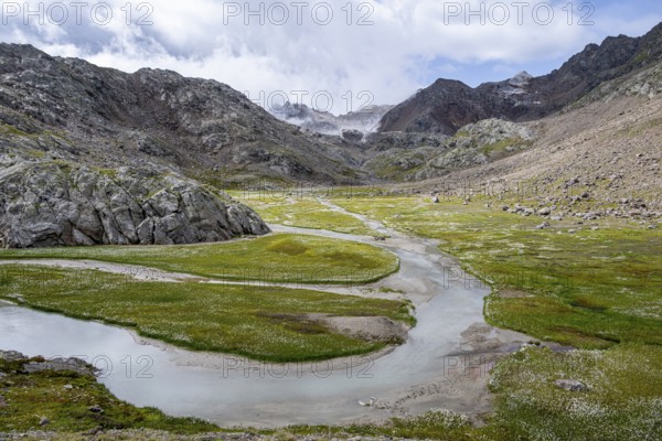 River flowing through a high alpine mountain valley, Upper Senner Egete, Stubai Alps, near Ridnaun, South Tyrol, Italy