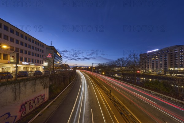 Motorway, modern architecture, river Saar, light traces, reflectors, headlights, flashing light, blue hour, deep blue evening sky, cumulus clouds, motorway A620, Saarbrücken, state capital, regional association Saarbrücken, Saarland, Germany