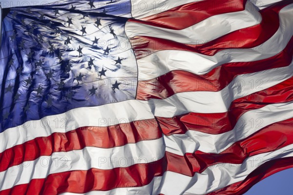 Dramatic backlit american flag waving in the wind