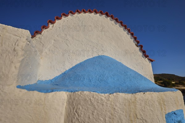 Close-up of a white church vault with blue accents under a blue sky, chapel, church, Agios Isidoros, rocky islet, Gourna Bay, Kokkali, Leros, Dodecanese, Greek Islands, Greece