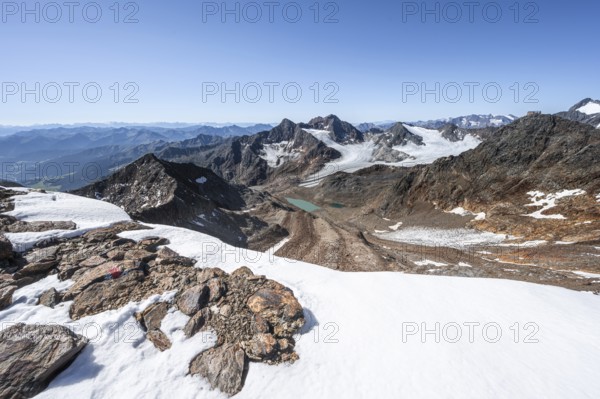 View of mountain basin with blue glacier lakes, behind summit Becher with Becherhaus, glacier Übeltalferner and summit Königshofspitz, descent from summit Wilder Freiger to Roter Grat, Stubai Alps, South Tyrol, Italy