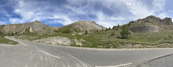 Panoramic view of pass road Mountain road on northern ramp Northern ascent Descent in front of pass summit of Alpine pass Col d'Izoard, Col de l'Izoard, Cottian Alps, Route des Grandes Alpes, Département Hautes-Alpes, France